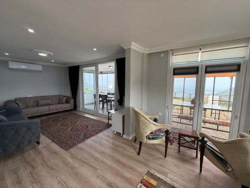 a living room with a couch and chairs at Atlas Tiny House in Perşembe