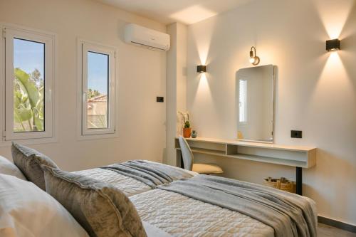 a bedroom with a bed and a mirror at X luxury suites in Argostoli