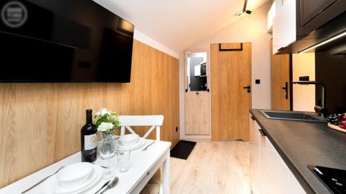 a kitchen with a table with plates and flowers on it at Apartamenty Good Time - Belle View - Centrum in Szklarska Poręba