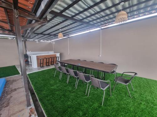 a conference room with a table and chairs on green grass at El Eden de la Familia in Choluteca