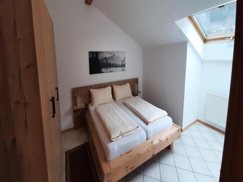 a bedroom with a bed in a room with a window at Stay with Wellness Access in Bayrischzell