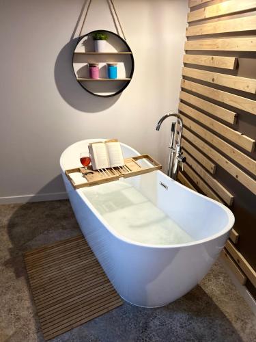 a bath tub in a bathroom with a pendant light at La Ville - Rouge in Zator