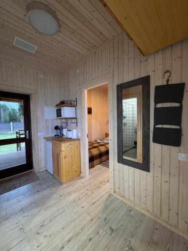 a room with a mirror on the wall of a cabin at Brunella house at Villa Vlada in Gāršmuiža