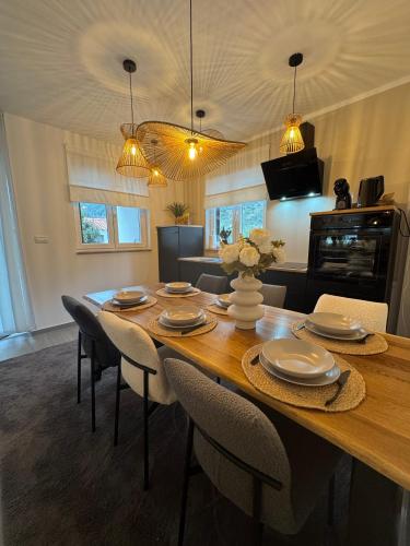 a dining room with a wooden table and chairs at Apartman Magic View in Baška Voda