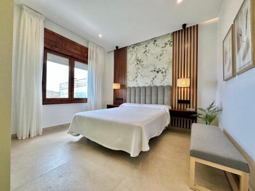 a bedroom with a large white bed and a window at Golf Sea&Pool Cactus Villa in Buenavista del Norte