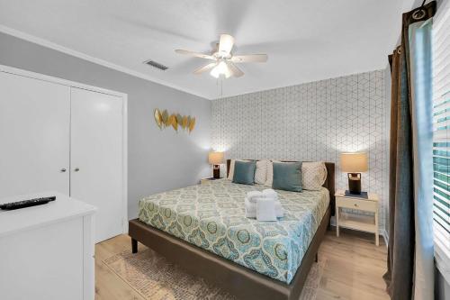 a bedroom with a bed and a ceiling fan at SMV Coastal Retreat Near Shore in Jacksonville Beach