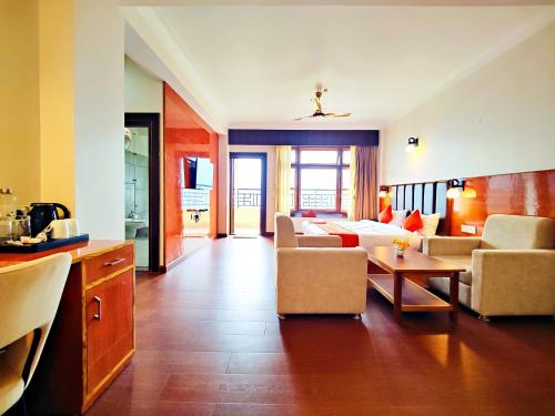 a living room with a couch and a table at Jo'stel Heritage - Tadong Tashi Hotel and Spa - Near MG Marg - 4 Star Hotel in Gangtok