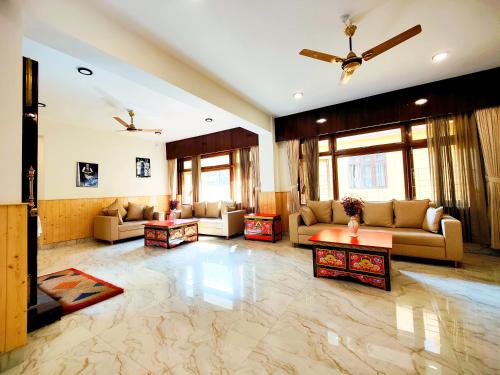a large living room with couches and tables at Jo'stel Heritage - Tadong Tashi Hotel and Spa - Near MG Marg - 4 Star Hotel in Gangtok