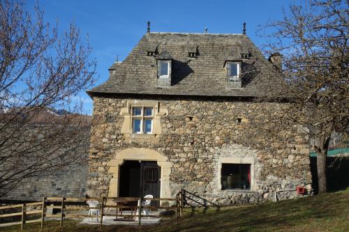 an old stone building with a roof on a hill at A Casti in La Celle-sous-Gouzon
