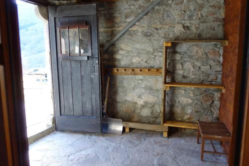 a door in a room with a stone wall at A Casti in La Celle-sous-Gouzon