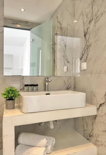a bathroom with a sink and a mirror at Zen Apartments in Laganas