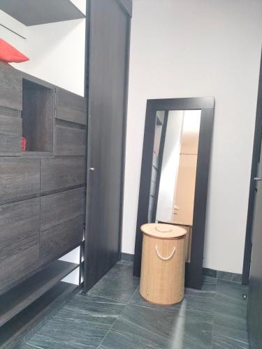a bathroom with a trash can in front of a mirror at Loft SB in Aguascalientes
