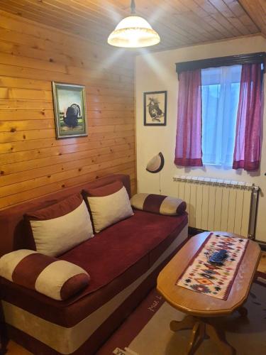 a bedroom with a bed and a table in it at Vasilije Apartment in Žabljak