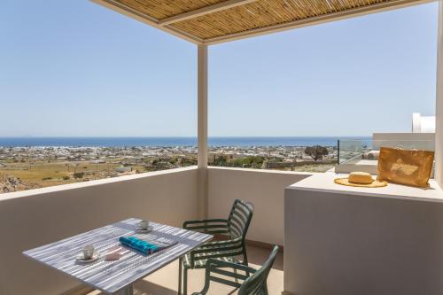 a table and chairs on a balcony with a view at Depalyma Suites in Emporio Santorini