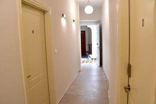 a hallway with a white door and a hallway with at Aegina-town-old-center in Aegina Town