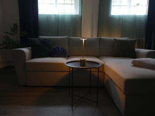 a living room with a couch and a table at Atlantis Apartment in Greifswald
