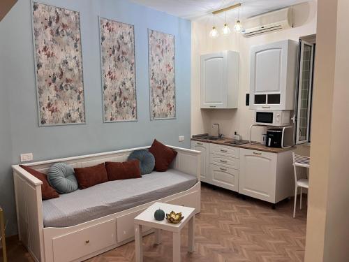 a living room with a couch and a kitchen at Guest house thats amore roma in Rome