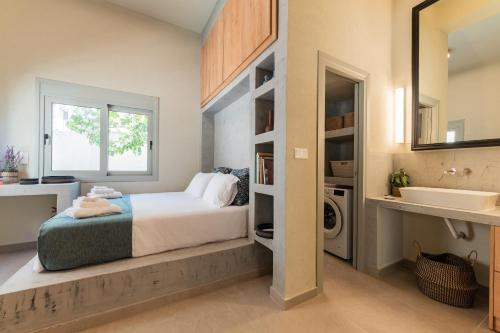 a bedroom with a bed and a sink and a mirror at Lemontrees Residences in Rhodes Town