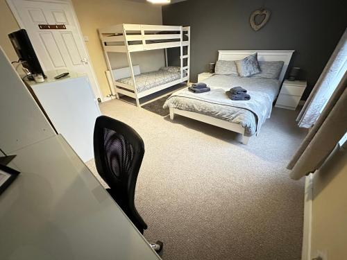 a small bedroom with a bed and a bunk bed at Llanidloes Townhouse-pet-friendly-sleeps 7-Mid Wales in Llanidloes