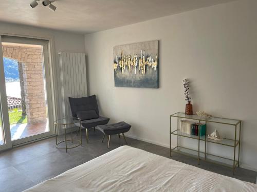 CarmineにあるCasa Stefanie -Traum Ferienwohnung mit Seesichtのベッドと椅子とテーブルのある寝室