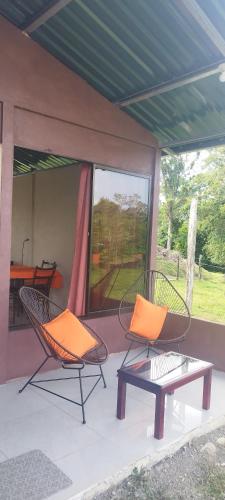 two chairs and a table on a porch at Boca Tapada Inn in Boca Tapada
