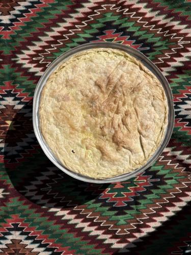 a bowl of food sitting on a patterned table at Voyage House in the countryside Polen in Korçë