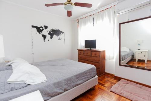 a bedroom with a bed and a mirror and a window at Candioti I Apartment - Santa Fe in Santa Fe