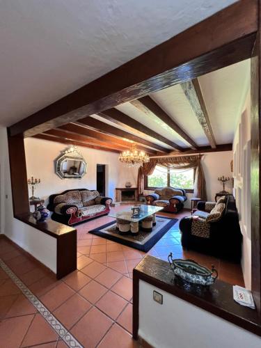a large living room with couches and a table at Mini-Villa à deux pas de la plage in Cabo Negro