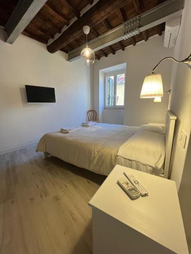 a bedroom with a bed and a table and a television at Il Pescatore in Marciana Marina