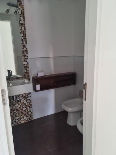 a bathroom with a toilet and a sink at Forest2 - 1306 in Punta del Este