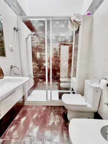 a bathroom with a shower and a toilet and a sink at CAN HOST YUMBO - Private Terrace AA in San Bartolomé