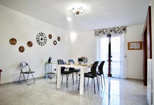 a dining room with a white table and chairs at Lecce Holiday Rentals in Lecce