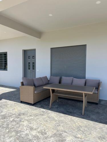 a large couch sitting in a room next to a wall at Koroni Luxury Apartment in Koroni