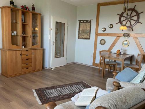 a living room with a couch and a table at Tief 10 Seebär 1004 in Wangerland