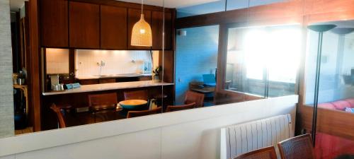 a kitchen and dining room with a table and chairs at Rooms in Casa da Foz do Rio in Caminha