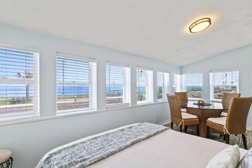 a bedroom with a bed and a table with chairs at Sea Legs | Flagler Beach in Flagler Beach