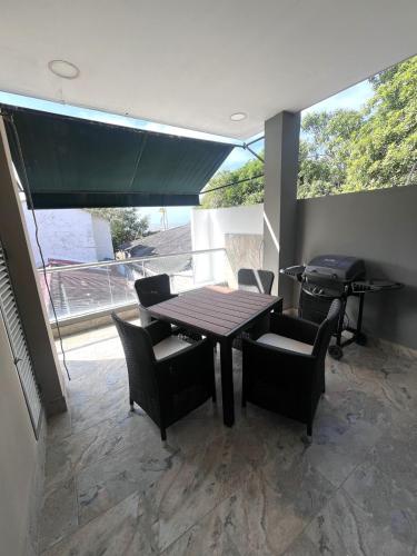 a dining room with a table and chairs and a window at Mar, Hamaca, BBQ y Cocina, Hogar Entre Olas in Puerto Colombia