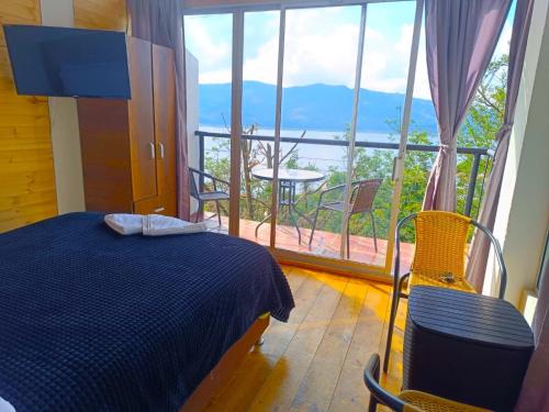 a bedroom with a bed and a balcony with a view at Lakeview Apartment in the Heart of Guatavita Bunk bed for Kids in Guatavita