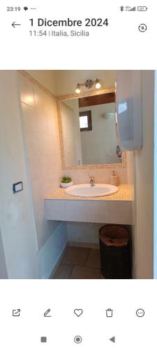 a bathroom with a sink and a mirror at Taormina Villa Ibiscus Alcantara in Gaggi
