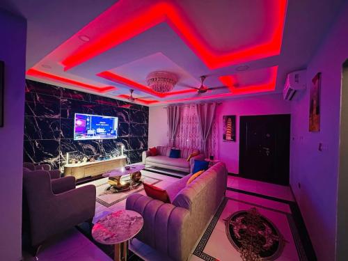 a living room with pink lights on the ceiling at Lexsarp Apartments in Tema