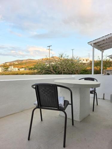 a table and a chair sitting on a patio at Calypso Heaven in Santorini