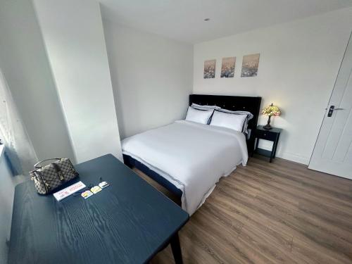 a hotel room with a bed and a table at Stay in City Centre 2 in Belfast
