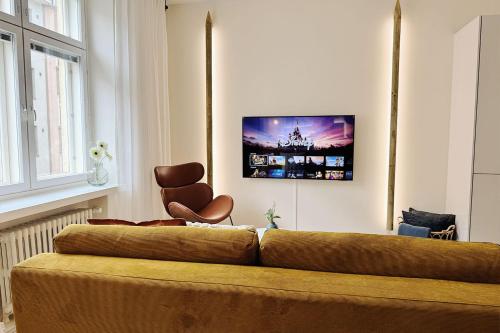 a living room with a couch and a chair at Luxury 3-Bedroom Suite on Most Beautiful Street of Helsinki in Helsinki