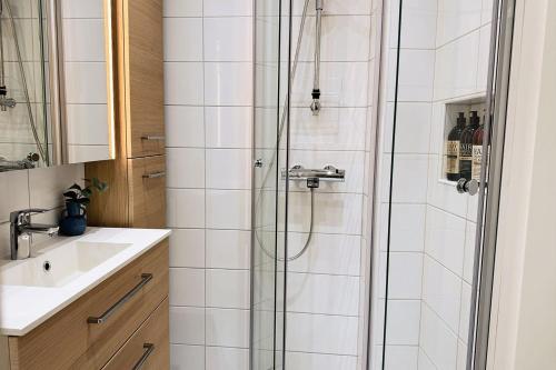 a bathroom with a shower and a sink at Luxury 3-Bedroom Suite on Most Beautiful Street of Helsinki in Helsinki