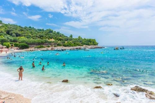 a group of people in the water at a beach at Hotel - Teranea City Hvar in Hvar