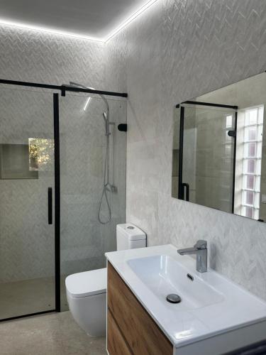 a bathroom with a sink and a toilet and a shower at Can Vilàs in Muro