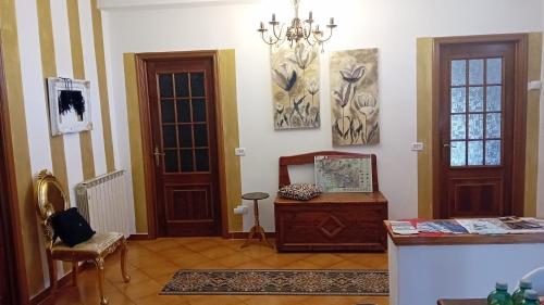 a living room with two doors and a table at La Sosta in Lunigiana in Monti di Licciana Nardi