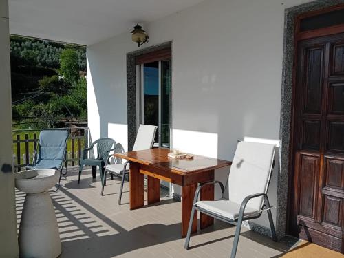 a wooden table and chairs on a patio at La Sosta in Lunigiana in Monti di Licciana Nardi