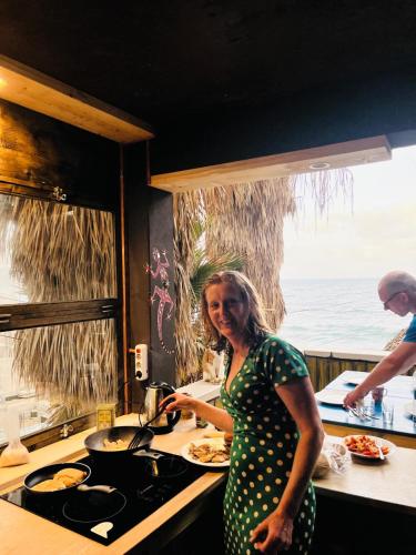 a woman standing in a kitchen preparing food at Black Mamba in Paul