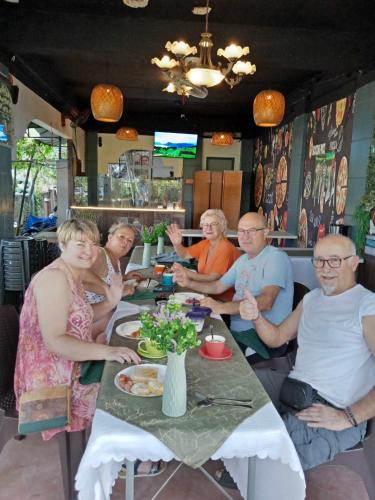 a group of people sitting at a table at BZ Hostel Cebu in Lapu Lapu City